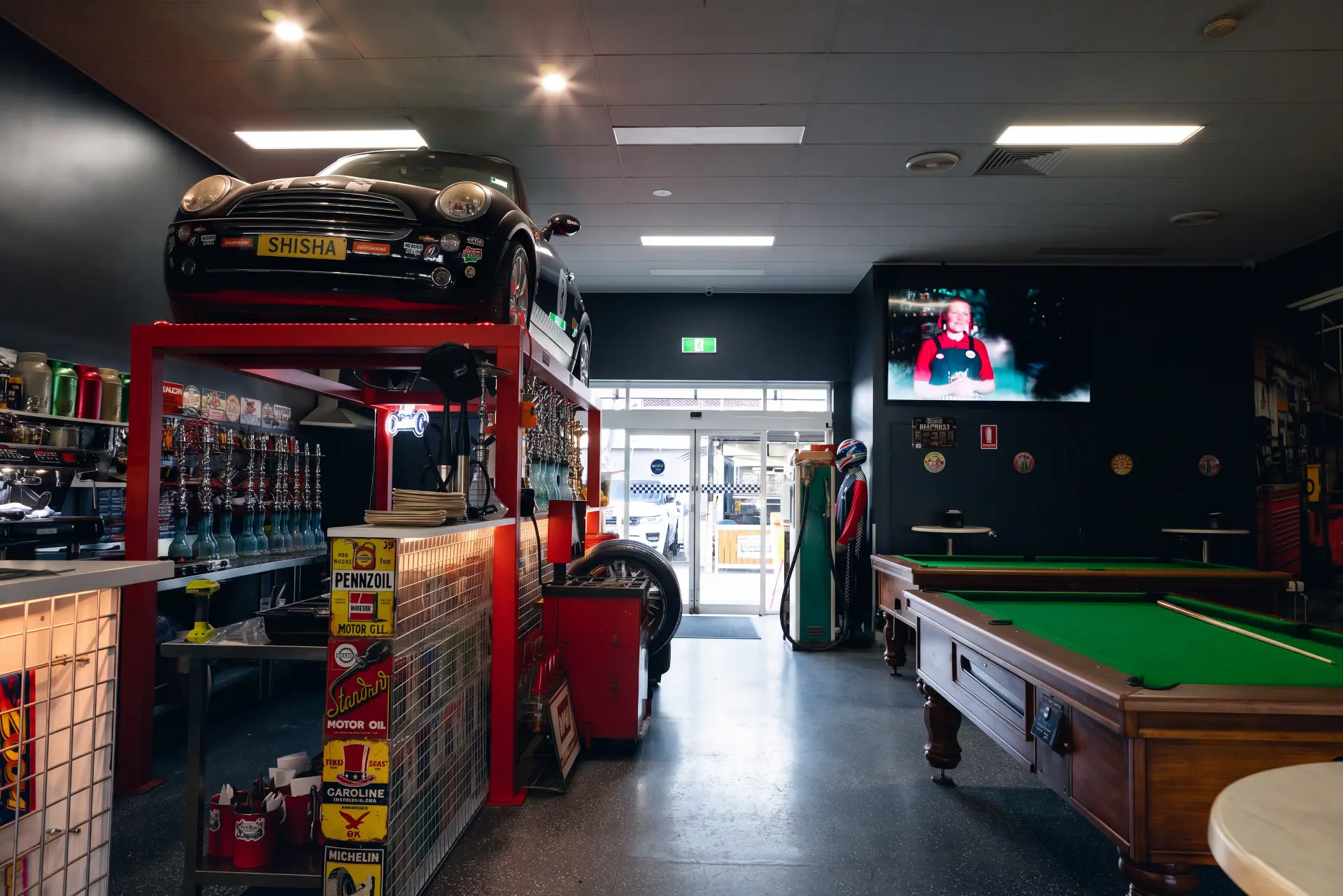 The shisha station under the black Mini Cooper with pool tables beyond